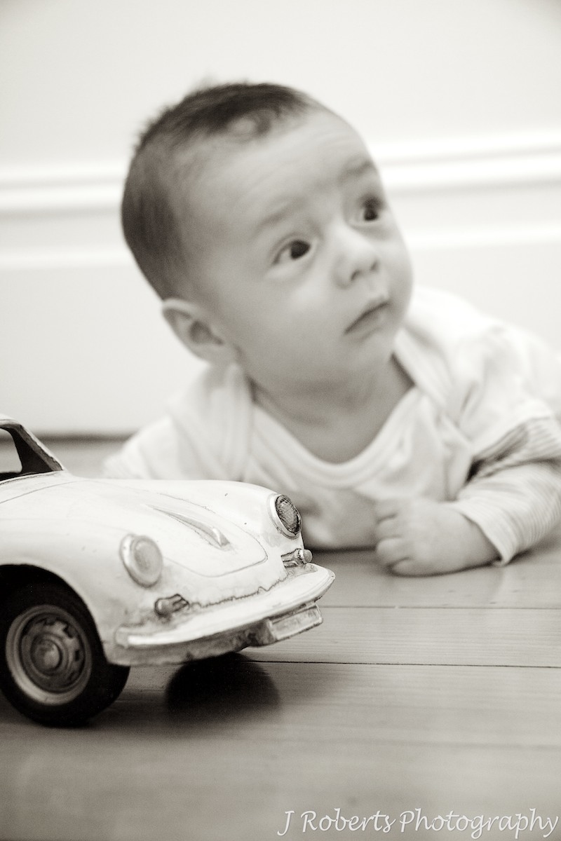 Baby with old volkswagon toy car - baby portrait photography sydney